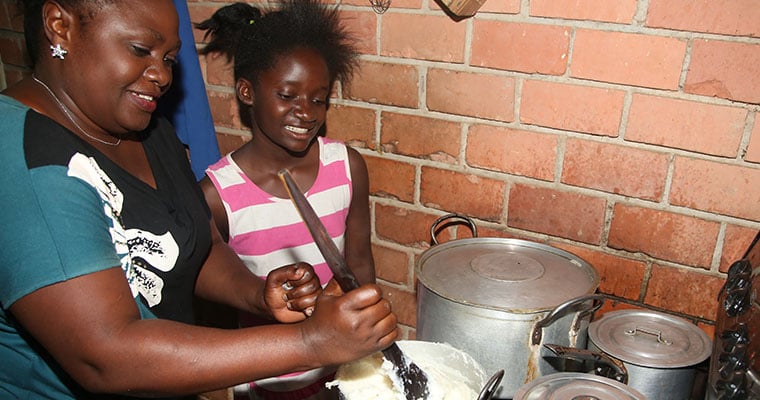 en kvinna och en flicka rör i kastruller